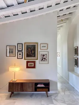 a room with a table and pictures on the wall at La Bohéme in Jerez de la Frontera