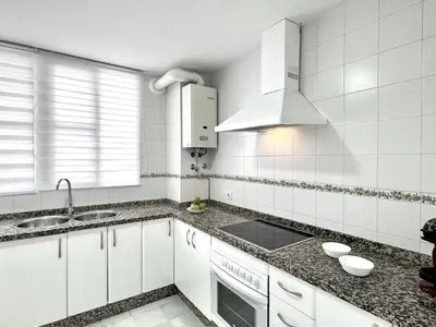a white kitchen with a sink and a stove at Sibs Sanlucar Bajamar - Bright & Central in Sanlúcar de Barrameda