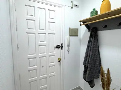 a bathroom with a white door and a shelf at Sibs Sanlucar Bajamar - Bright & Central in Sanlúcar de Barrameda