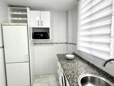 a small kitchen with a sink and a refrigerator at Sibs Sanlucar Bajamar - Bright & Central in Sanlúcar de Barrameda