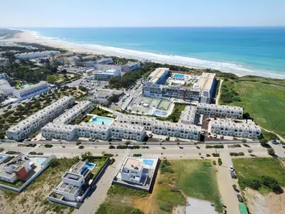 an aerial view of a resort near the beach at Lujoso chalet con jardín privado a 300 metros de la playa in Conil de la Frontera