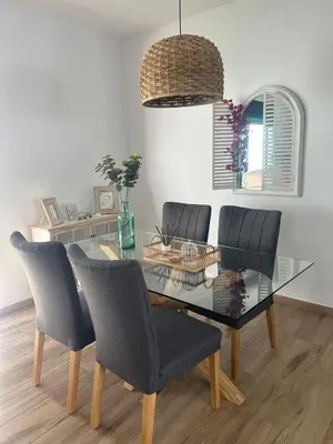 a dining room with a glass table and chairs at Chalet Familiar NUEVO-10min Cádiz Capital in Puerto Real