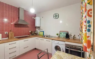 a kitchen with a sink and a washing machine at Family Oasis in Chipiona - Pool - Terrace - Padel in Cádiz