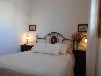 a bedroom with a white bed with two pillows at Studio Sleeps 4 with Terrace in Chipiona