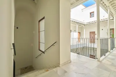 a clock on the side of a wall in a building at Refugio de Visitación in Jerez de la Frontera