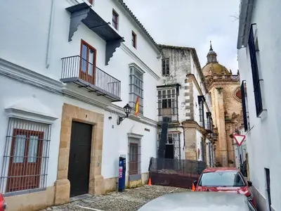 a car parked in front of a white building at Refugio de Visitación in Jerez de la Frontera