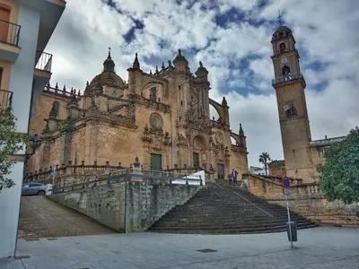 an old building with stairs and a clock tower at Refugio de Visitación in Jerez de la Frontera