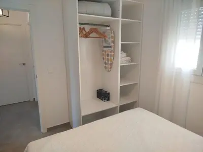 a bedroom with a closet with a surfboard in it at Pacifico conil in Cádiz