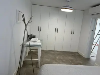 a bedroom with white cabinets and a chair in a room at Casa Flamenco in El Cuervo