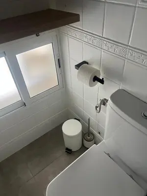 a small bathroom with a toilet and a window at Casa Flamenco in El Cuervo