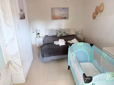 a bedroom with a bed and a baby crib at Mar de Luz Boutique in Novo Sancti Petri