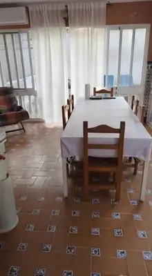 a dining room with a white table and chairs at Mar de Luz Boutique in Novo Sancti Petri