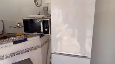 a microwave oven sitting on a counter in a kitchen at Mar de Luz Boutique in Novo Sancti Petri