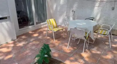 a table and chairs sitting on a patio at Mar de Luz Boutique in Novo Sancti Petri