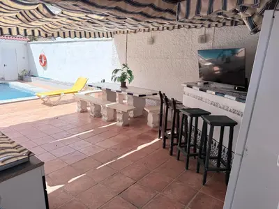 a patio with a table and chairs and a pool at Mar de Luz Boutique in Novo Sancti Petri