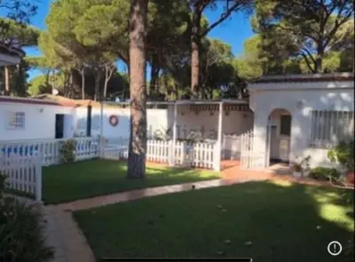 a house with a white fence and a yard at Mar de Luz Boutique in Novo Sancti Petri