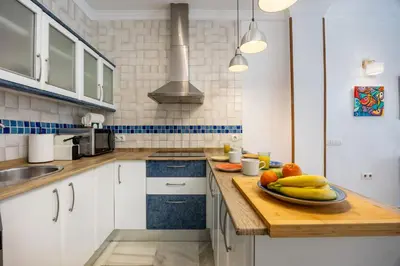 a kitchen with a plate of fruit on a counter at Grand Marina Suite - Puerto Sherry in El Puerto de Santa María