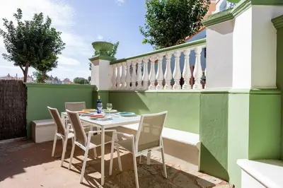 a patio with a table and chairs on a balcony at Grand Marina Suite - Puerto Sherry in El Puerto de Santa María