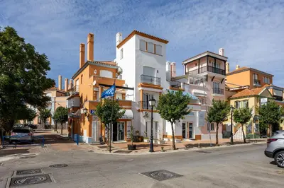 a group of buildings on a city street at Grand Marina Suite - Puerto Sherry in El Puerto de Santa María
