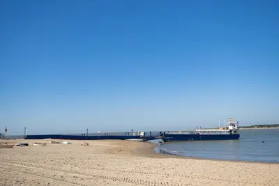 a large boat is docked at a beach at Casa Salmedina in Sanlúcar de Barrameda