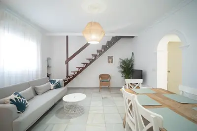 a living room with a couch and a table at Casa Salmedina in Sanlúcar de Barrameda