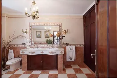 a bathroom with a sink and a mirror and a toilet at Casa Palacete en el corazón de Cádiz in Paterna de Rivera