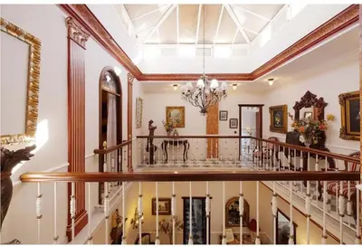 a large hallway with a staircase in a house at Casa Palacete en el corazón de Cádiz in Paterna de Rivera
