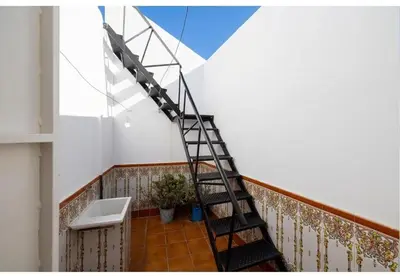 a stairwell in a room with a ladder at Casa Palacete en el corazón de Cádiz in Paterna de Rivera