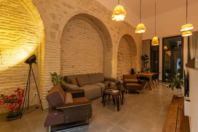 a lobby with a couch and chairs and a table at Musart Entre Artes in Jerez de la Frontera