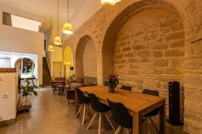 a kitchen and dining room with a table and chairs at Musart Entre Artes in Jerez de la Frontera
