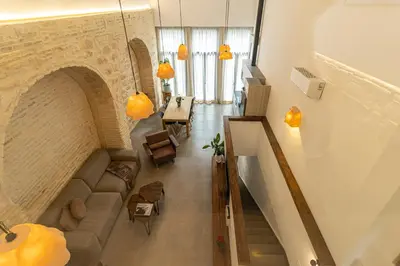a view of a living room with a couch and a staircase at Musart Entre Artes in Jerez de la Frontera