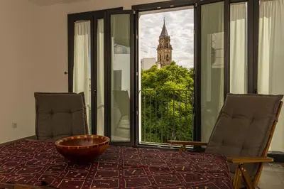 a room with a table with a view of a church at Musart Entre Artes in Jerez de la Frontera