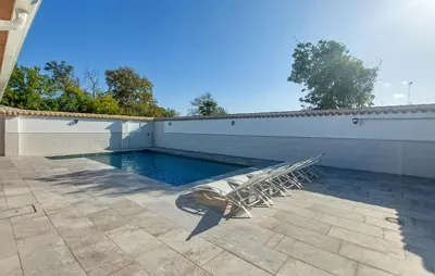 a swimming pool with two chairs and a wall at Lovely Home In San Antoniojerez De L With Wifi in La Barca de la Florida