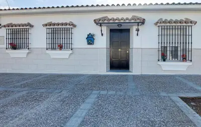 a white building with a door and three windows at Lovely Home In San Antoniojerez De L With Wifi in La Barca de la Florida