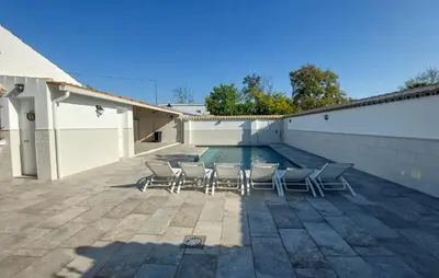 a group of chairs sitting next to a swimming pool at Lovely Home In San Antoniojerez De L With Wifi in La Barca de la Florida
