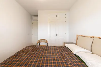 a room with a couch and a plaid blanket at Doñana Loft 17 in Sanlúcar de Barrameda