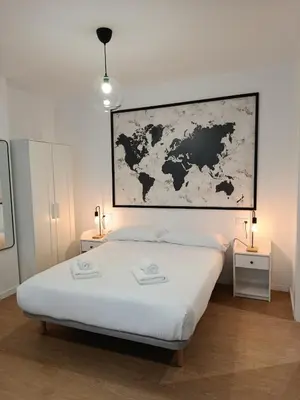 a bedroom with a bed with a map on the wall at Allo Apartments Santa María IV Centro Loft in Jerez de la Frontera