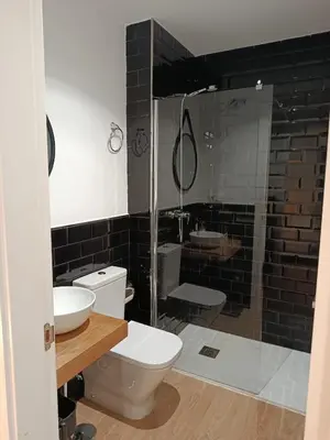 a bathroom with a toilet and a sink and a shower at Allo Apartments Santa María IV Centro Loft in Jerez de la Frontera
