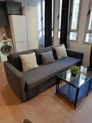 a living room with a couch and a glass table at Allo Apartments Santa María IV Centro Loft in Jerez de la Frontera
