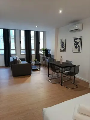 a living room with a couch and a table at Allo Apartments Santa María IV Centro Loft in Jerez de la Frontera