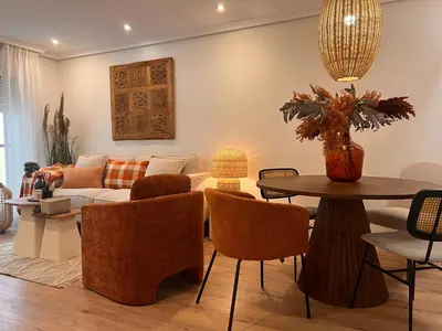 a living room with a couch and a table at Hidden Gem GRAN TEATRO FALLA SUITES by ApartmentsinCadiz in Cádiz
