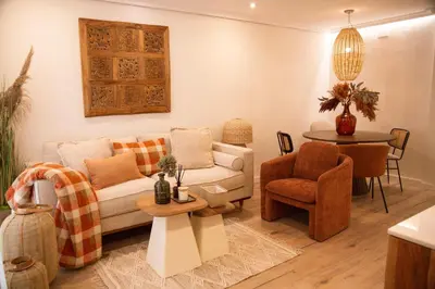 a living room with a couch and a table at Hidden Gem GRAN TEATRO FALLA SUITES by ApartmentsinCadiz in Cádiz