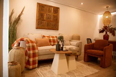 a living room with a couch and a table at Hidden Gem GRAN TEATRO FALLA SUITES by ApartmentsinCadiz in Cádiz