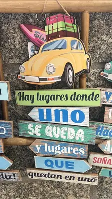 a sign with a car with luggage on top at Serenity Boutique Home in Chiclana de la Frontera