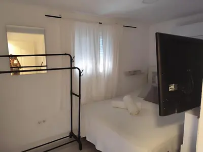 a bedroom with a bed and a television in it at Serenity Boutique Home in Chiclana de la Frontera