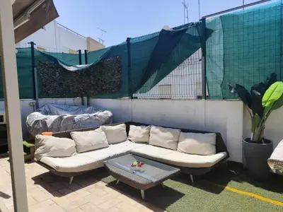 a couch and a table on a patio at Serenity Boutique Home in Chiclana de la Frontera