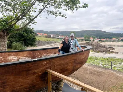 a man and a woman sitting in a wooden boat at Serenity Boutique Home in Chiclana de la Frontera
