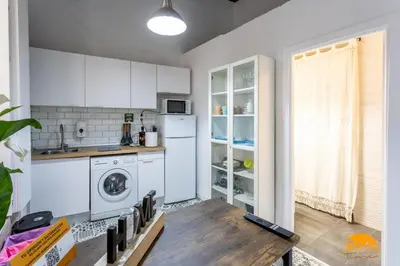a kitchen with a washer and dryer in a room at Adolfo de Castro by Cadiz Time in Cádiz