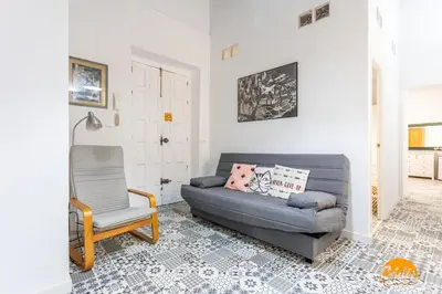 a living room with a couch and a chair at Adolfo de Castro by Cadiz Time in Cádiz