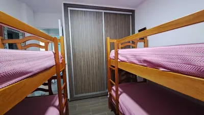 two bunk beds in a room with a door at Apartamento en primera linea de playa in Novo Sancti Petri